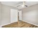 Bedroom with hardwood floors, a ceiling fan, closet, and an entry door at 7625 E 35Th St, Indianapolis, IN 46226