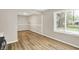 Dining area with wood-look floors and natural light from a large window at 7625 E 35Th St, Indianapolis, IN 46226