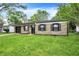 Charming single-story home featuring a stone facade, attached garage, and a well-maintained lawn at 7625 E 35Th St, Indianapolis, IN 46226