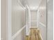 Hallway featuring modern trim and wood-look flooring at 7625 E 35Th St, Indianapolis, IN 46226