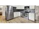 Modern kitchen featuring stainless steel appliances, white cabinets, and stylish backsplash at 7625 E 35Th St, Indianapolis, IN 46226