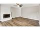Spacious living room featuring a fireplace, ceiling fan, and wood flooring at 7625 E 35Th St, Indianapolis, IN 46226