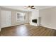 Inviting living room featuring a white fireplace, ceiling fan, and beautiful hardwood floors at 7625 E 35Th St, Indianapolis, IN 46226