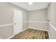 Neutral room featuring modern trim and wood-look flooring at 7625 E 35Th St, Indianapolis, IN 46226