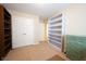 Neutral bedroom has closet, bookshelf and chest for organized storage solutions at 808 Heartland Ln, Brownsburg, IN 46112