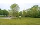 Grassy community park with swingset, bridge and creek with trees at 808 Heartland Ln, Brownsburg, IN 46112