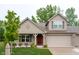 Charming exterior elevation of home featuring brick accents, covered porch, attached garage and manicured front lawn at 808 Heartland Ln, Brownsburg, IN 46112