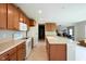 Spacious kitchen featuring light countertops, wooden cabinets, and modern appliances at 808 Heartland Ln, Brownsburg, IN 46112