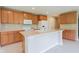 Open kitchen area featuring an island and matching appliances, providing ample space for cooking and storage at 808 Heartland Ln, Brownsburg, IN 46112