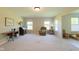 Bright living room with carpet floors and natural light, showcasing a cozy seating area at 808 Heartland Ln, Brownsburg, IN 46112