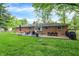 A view of the backyard featuring the brick house and patio with outdoor seating at 820 S Eaglewood Dr, Zionsville, IN 46077