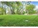 A large well-manicured back yard featuring mature trees and a storage shed at 820 S Eaglewood Dr, Zionsville, IN 46077