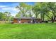 View of the backyard with a brick home, patio, outdoor seating, and fenced perimeter at 820 S Eaglewood Dr, Zionsville, IN 46077