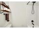 Modern bathroom with white subway tile shower, sleek black fixtures, and a stylish wooden shelf at 820 S Eaglewood Dr, Zionsville, IN 46077