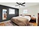 Cozy bedroom with dark accent wall, a comfortable bed, and an eye-catching area rug at 820 S Eaglewood Dr, Zionsville, IN 46077