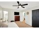 Bedroom featuring a large bed, TV, and dark closet doors at 820 S Eaglewood Dr, Zionsville, IN 46077