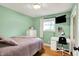 Light green bedroom with a bed, a desk, and a white dresser at 820 S Eaglewood Dr, Zionsville, IN 46077