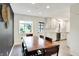Bright dining area featuring a wooden table, neutral walls, and access to the kitchen at 820 S Eaglewood Dr, Zionsville, IN 46077