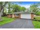Inviting brick home with an attached garage, landscaped yard, and a paved driveway at 820 S Eaglewood Dr, Zionsville, IN 46077