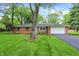 Charming single-story brick home featuring a well-maintained lawn and attached garage at 820 S Eaglewood Dr, Zionsville, IN 46077