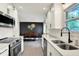 Kitchen with dining space, showcasing white cabinets, stainless steel appliances and sleek countertops at 820 S Eaglewood Dr, Zionsville, IN 46077