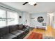 Bright living room boasts wood floors, a plush couch, and a stylish ceiling fan at 820 S Eaglewood Dr, Zionsville, IN 46077