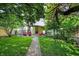 Lush backyard featuring vibrant green grass, a stone pathway, and cozy patio furniture, perfect for relaxation at 847 N Park Ave, Indianapolis, IN 46202