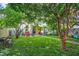 The backyard is adorned with healthy green grass, vibrant greenery, and a patio set for outdoor enjoyment at 847 N Park Ave, Indianapolis, IN 46202