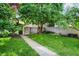 Picturesque backyard with a well-maintained lawn, a stone pathway, and a charming wooden fence, creating a private oasis at 847 N Park Ave, Indianapolis, IN 46202