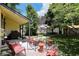 Charming brick patio features outdoor seating, perfect for entertaining in this landscaped backyard at 847 N Park Ave, Indianapolis, IN 46202