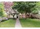 Gravel pathway leads to a charming outbuilding in the backyard with mature trees at 847 N Park Ave, Indianapolis, IN 46202