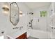Bright bathroom with white tile, glass enclosed shower, and warm vintage vanity at 847 N Park Ave, Indianapolis, IN 46202