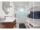 Bright bathroom featuring a vanity, glass shower, and custom shelving at 847 N Park Ave, Indianapolis, IN 46202