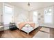 Bright bedroom with hardwood floors, neutral walls, ceiling fan, and plenty of natural light at 847 N Park Ave, Indianapolis, IN 46202