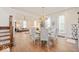 Open-concept dining room with hardwood floors, stylish chandelier, and easy access to the living room at 847 N Park Ave, Indianapolis, IN 46202