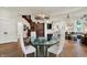 Elegant dining room with glass table and view into the adjoining living area at 847 N Park Ave, Indianapolis, IN 46202