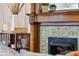Close up of an ornate fireplace with decorative tile and a wood mantel at 847 N Park Ave, Indianapolis, IN 46202