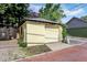 Detached one-car garage featuring a brick driveway and cream-colored siding, offering both parking and storage solutions at 847 N Park Ave, Indianapolis, IN 46202