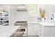 Bright, modern kitchen featuring white cabinetry, stainless steel appliances, and stylish finishes at 847 N Park Ave, Indianapolis, IN 46202