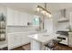 Updated white kitchen featuring modern appliances, a kitchen island, pendant lighting, and ample counter space at 847 N Park Ave, Indianapolis, IN 46202