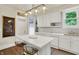 Bright kitchen with white cabinets, an island with seating, and modern lighting fixtures at 847 N Park Ave, Indianapolis, IN 46202