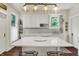 White kitchen with stainless steel appliances, quartz countertops, and a central island at 847 N Park Ave, Indianapolis, IN 46202