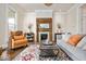 Cozy living room with a decorative fireplace, a comfortable sofa, and a colorful rug at 847 N Park Ave, Indianapolis, IN 46202