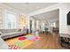 Spacious living room featuring a vibrant floral rug, hardwood floors, and stylish decor at 847 N Park Ave, Indianapolis, IN 46202