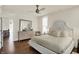 Comfortable main bedroom with hardwood floors, a ceiling fan, and large dresser at 847 N Park Ave, Indianapolis, IN 46202