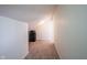 Attic space features carpet flooring, a mini fridge, neutral walls and ample natural light from the entry door at 895 Geronimo Dr, Greenfield, IN 46140