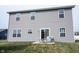 A gray two-story home with a grassy backyard and a patio set, ideal for outdoor relaxation at 895 Geronimo Dr, Greenfield, IN 46140