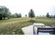 A vast backyard featuring well-maintained grass, mature trees, and a cozy patio area at 895 Geronimo Dr, Greenfield, IN 46140