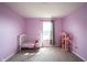 Charming Bedroom with window, carpet, neutral walls, and a dollhouse bookshelf, perfect for your little one at 895 Geronimo Dr, Greenfield, IN 46140