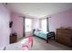 Bedroom featuring two bright windows with curtains, carpet, neutral walls, and a dresser at 895 Geronimo Dr, Greenfield, IN 46140
